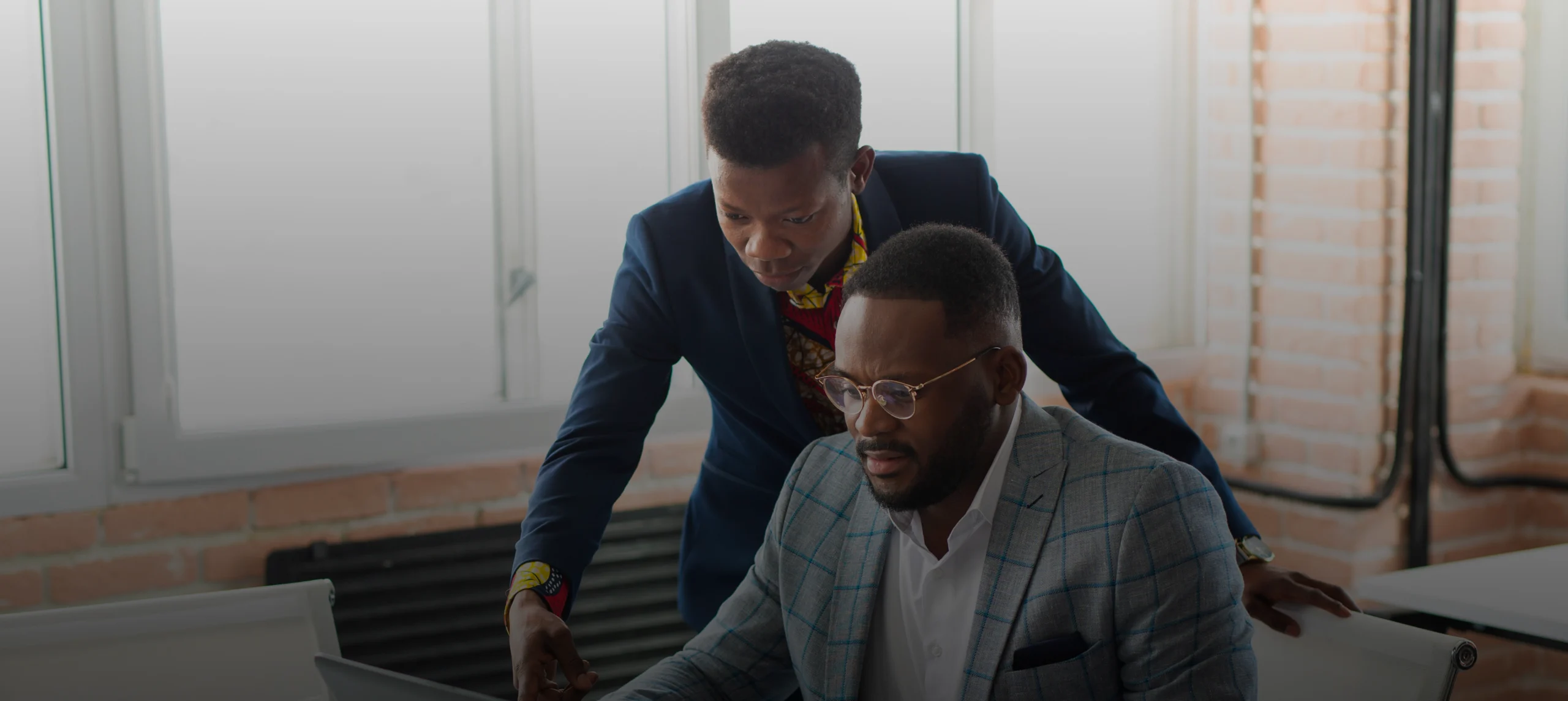 two-handsome-young-african-men-table-with-laptop 1